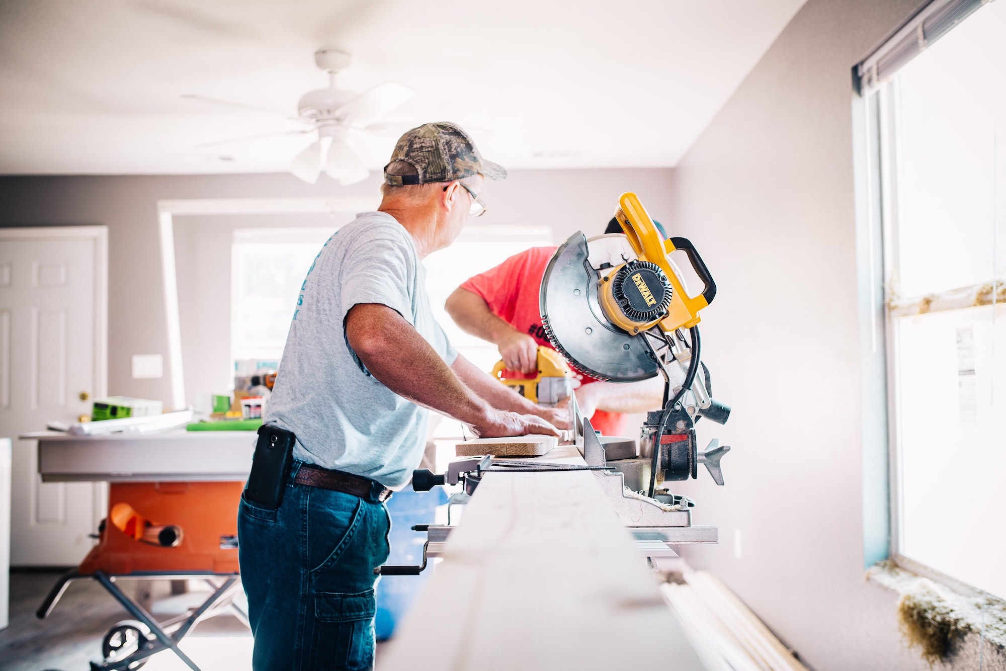 two men working on piece of wood